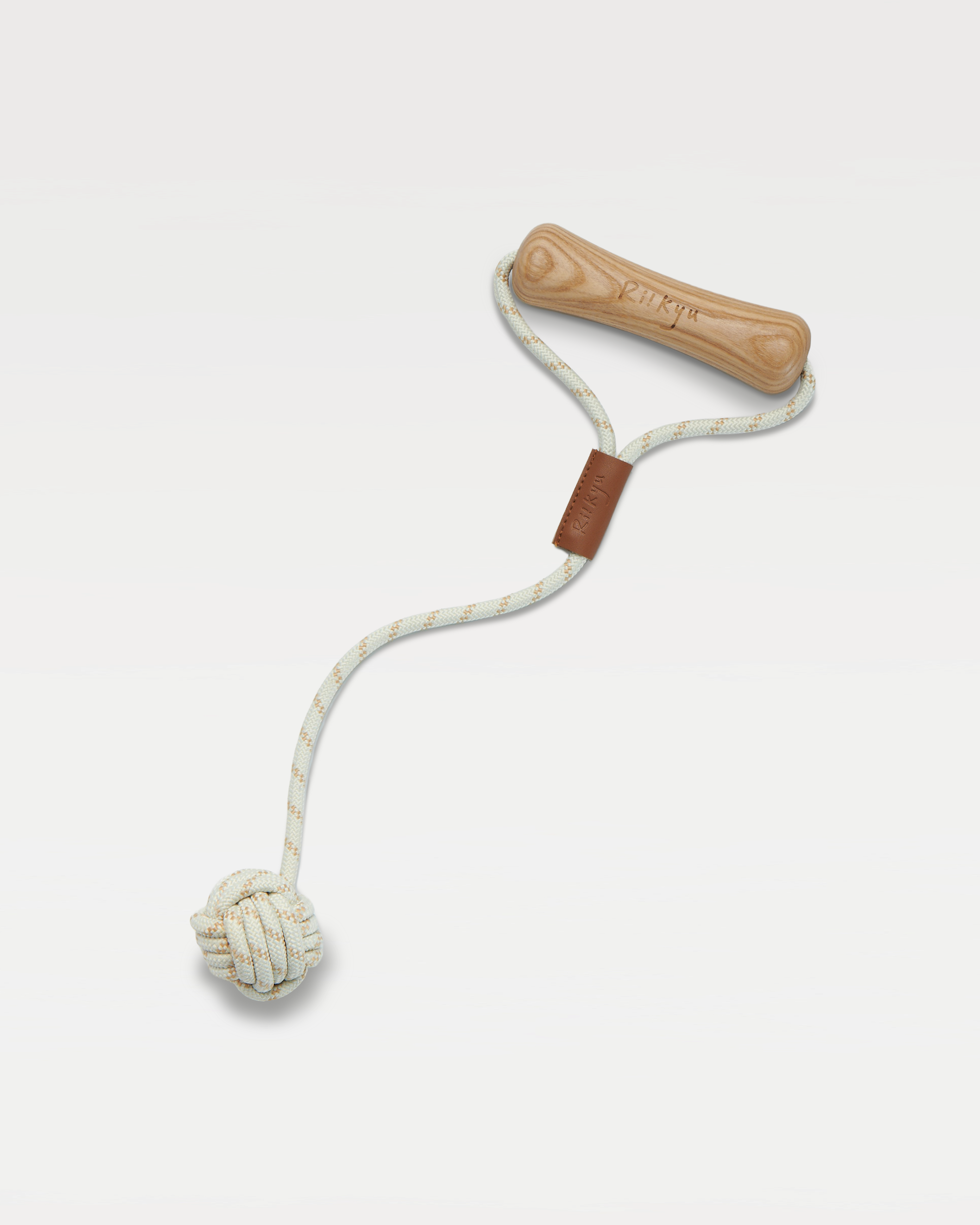 A dog toy with dog-bone-shaped handle and a ball