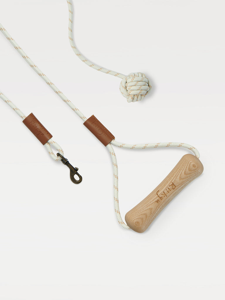 a leash with a handle in the shape of a dog bone and a toy ball