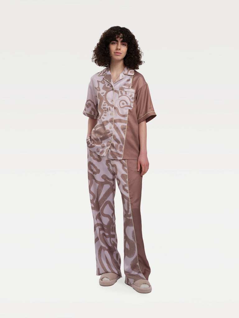 a female model standing in a pajama match set 
