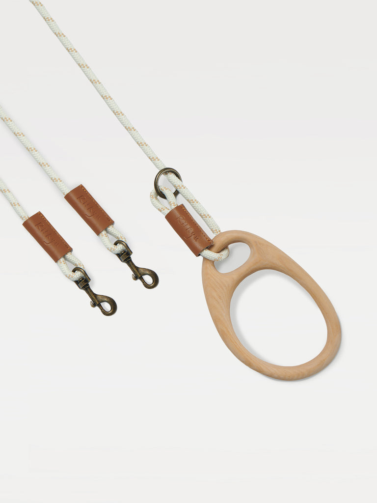 A dog leash for two pets with a ring handle