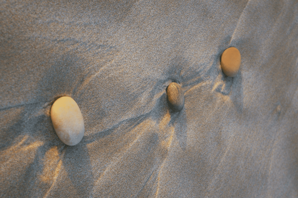 Three pebbles placed on the beach